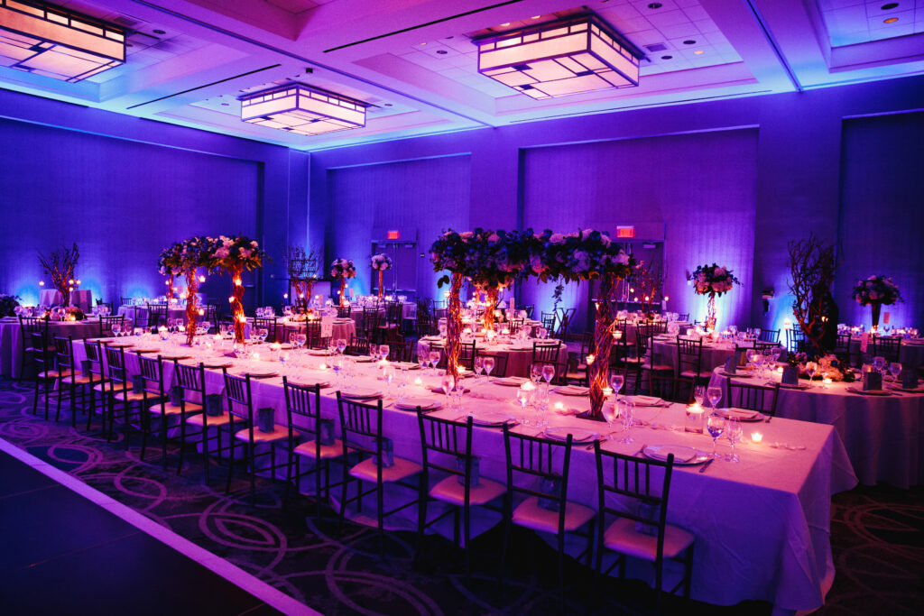 decorated banquet hall with flowers, rectangle table, chiavari c