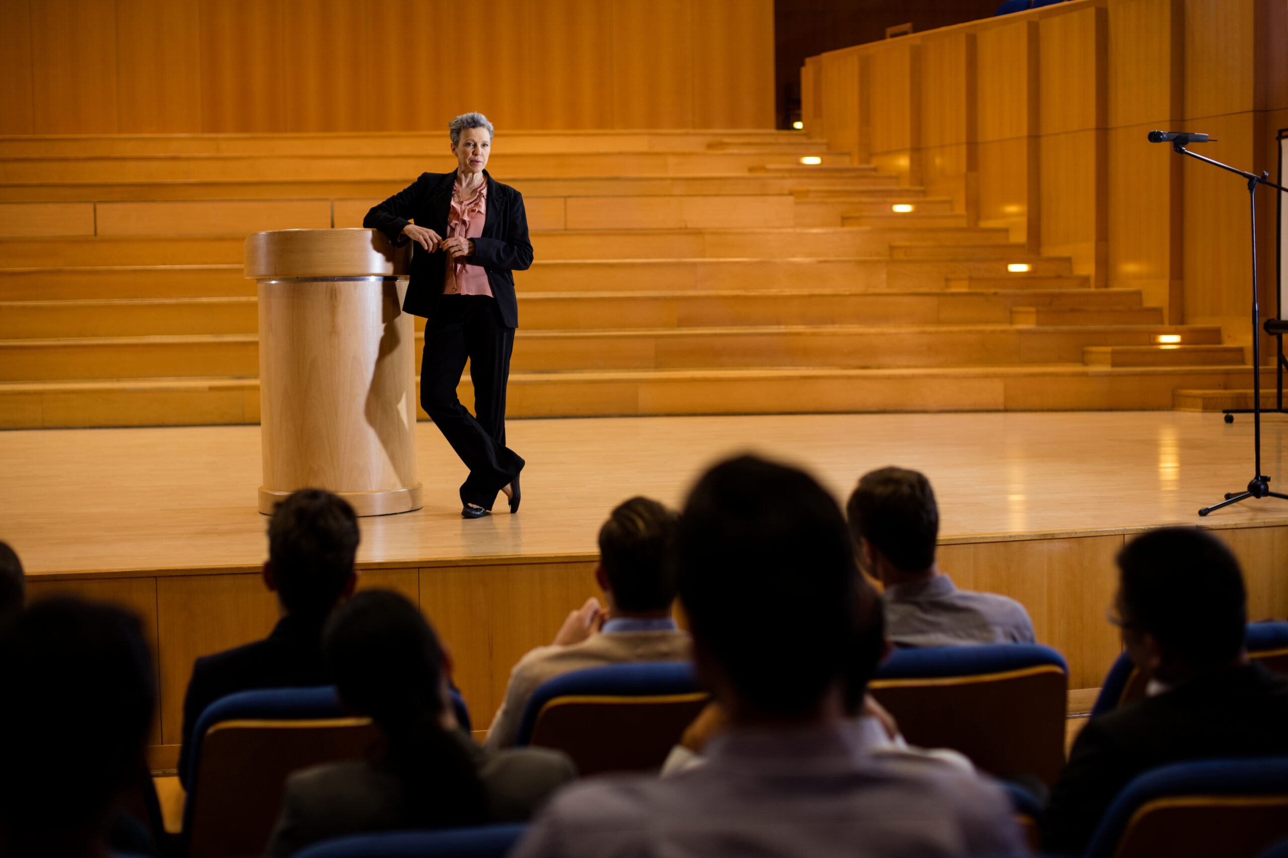 female business executive giving a speech at conference center